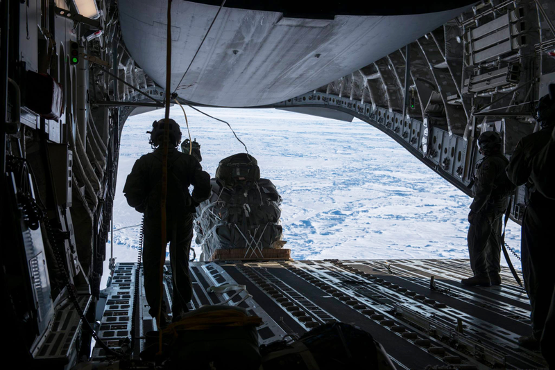 Illustration for article titled Check Out These Shots Of A C-17 Dropping Pararescuemen Over The Navy's Arctic OutpostÂ